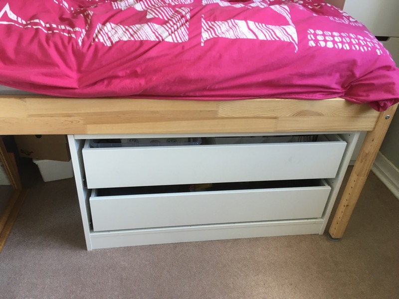 2 large drawers shown under a bed